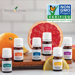 The Beginner's Guide To Using Essential Oils Properly Six bottles of essential oils arranged around fruit and blocks. Text on bottles from left to right: Peppermint, Orange, Basil, Grapefruit, Lemon, & Lavender